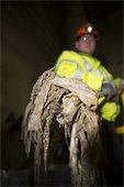 Photo credit MPCA – Sanitary sewer worker holding shovel full of non-degradable materials