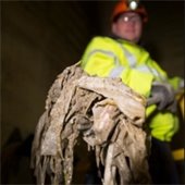 Photo credit MPCA – Sanitary sewer worker holding shovel full of non-degradable materials