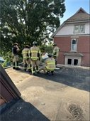 Firefighters on roof conducting training exercise